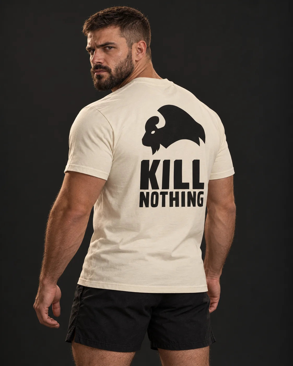 Kill Nothing Club - Slim Tee, cream, worn by an athlete, studio photo (AI-generated image)