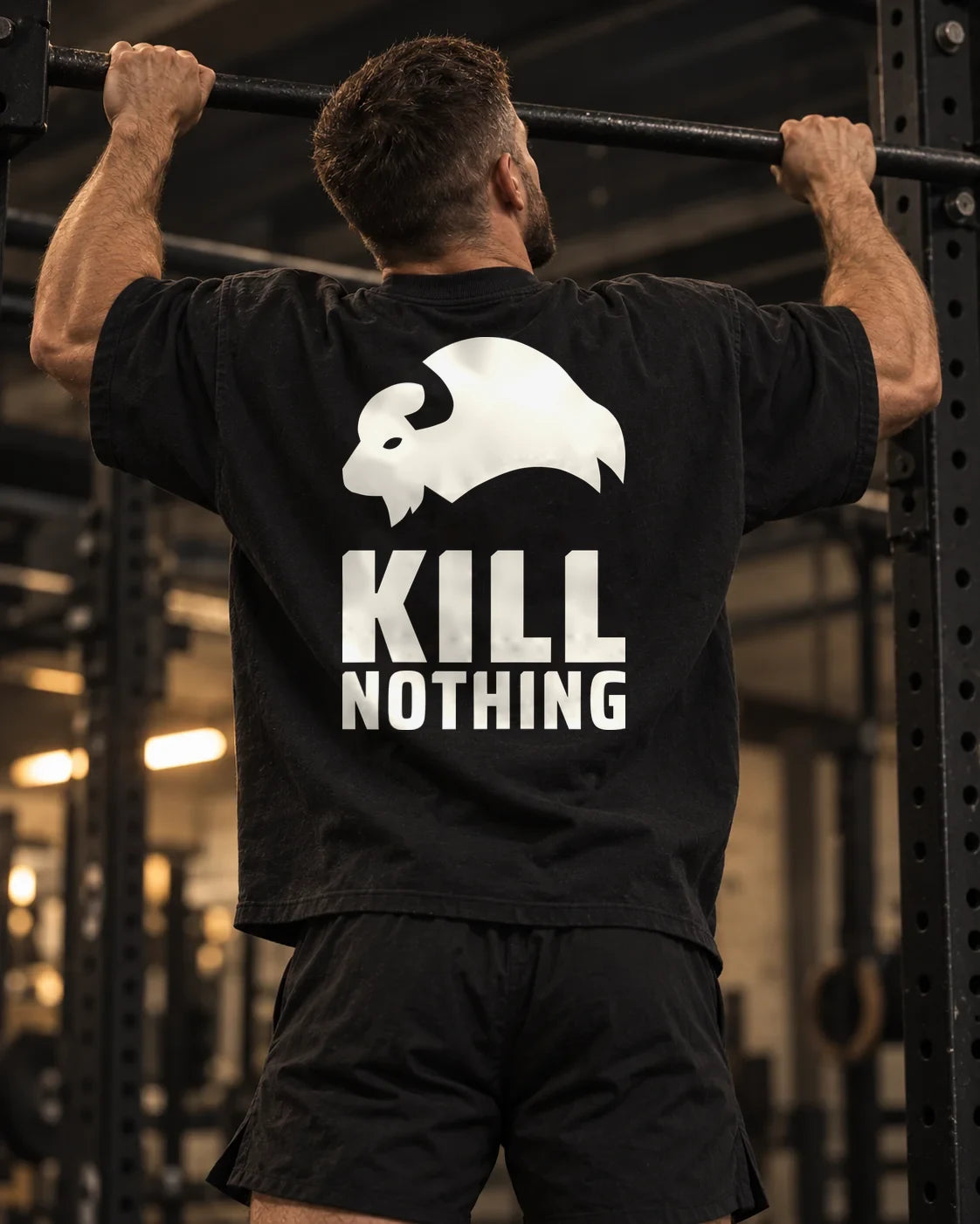 Kill Nothing Club - Oversized Tee, black, worn by an athlete in the gym (AI-generated image)