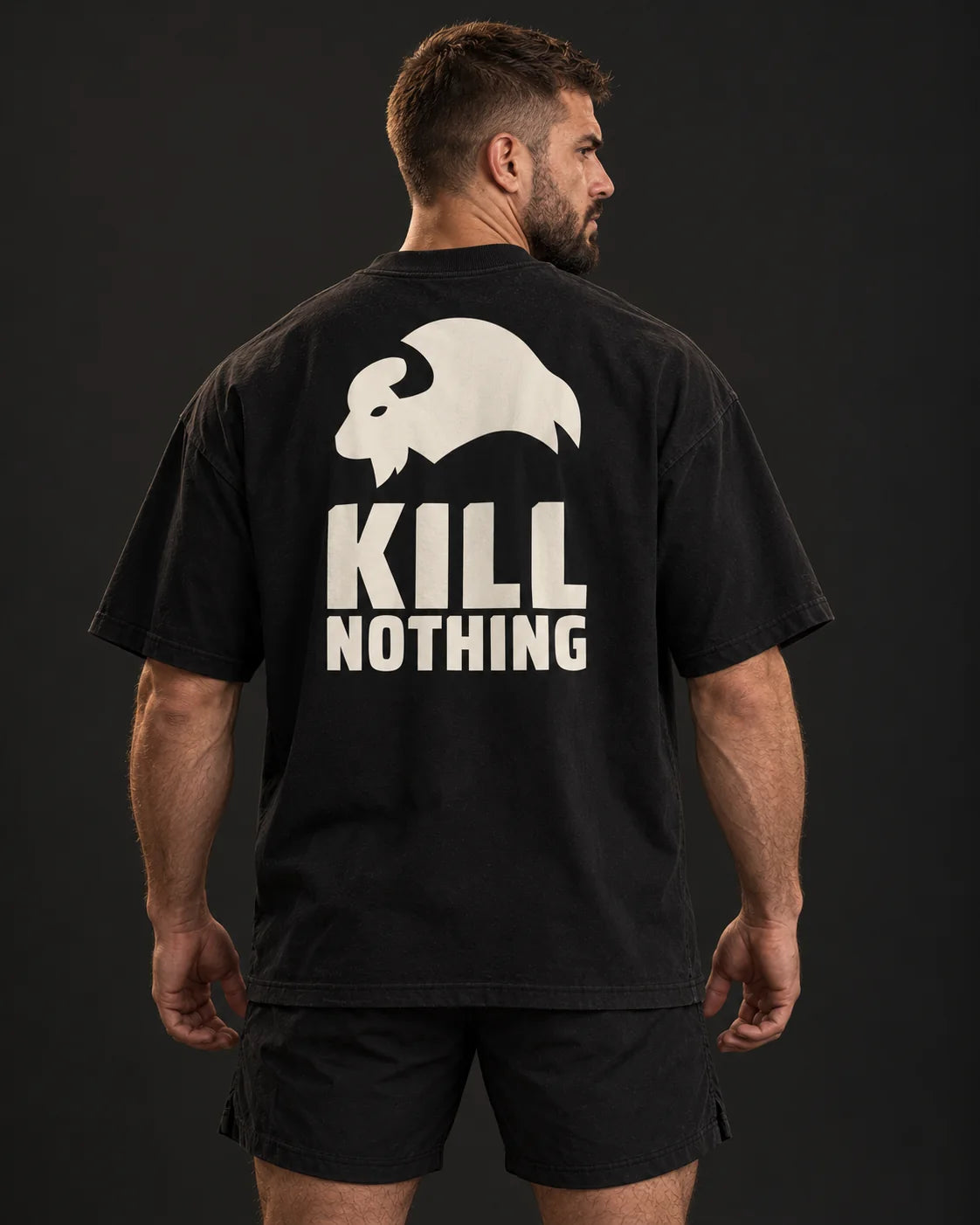 Kill Nothing Club - Oversized Tee, black, worn by an athlete, studio photo (AI-generated image)