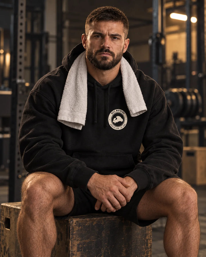 Club Crest - Hoodie, black, worn by an athlete in the gym (AI-generated image)