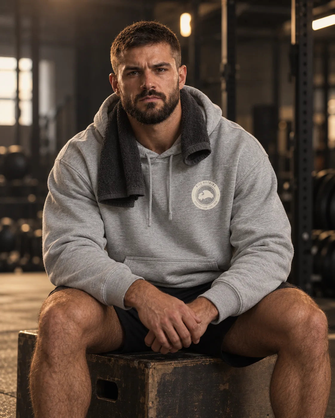 Club Crest - Hoodie, heather grey, worn by an athlete in the gym (AI-generated image)