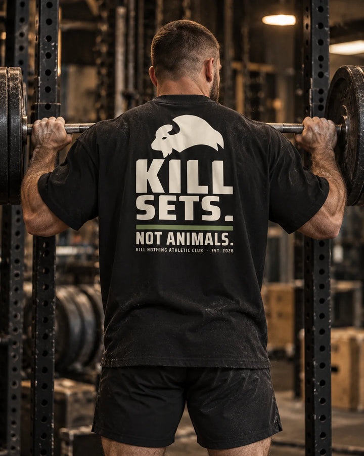 Kill Sets. Not Animals. - Oversized Tee, black, worn by an athlete in the gym (AI-generated image)