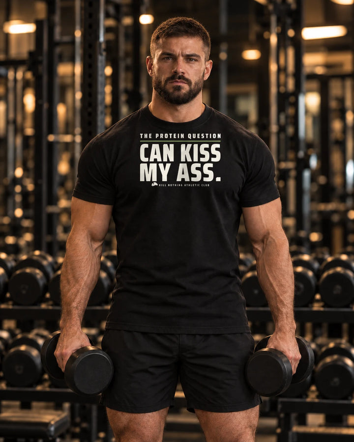 The Protein Question - Slim Tee, black, worn by an athlete in the gym (AI-generated image)