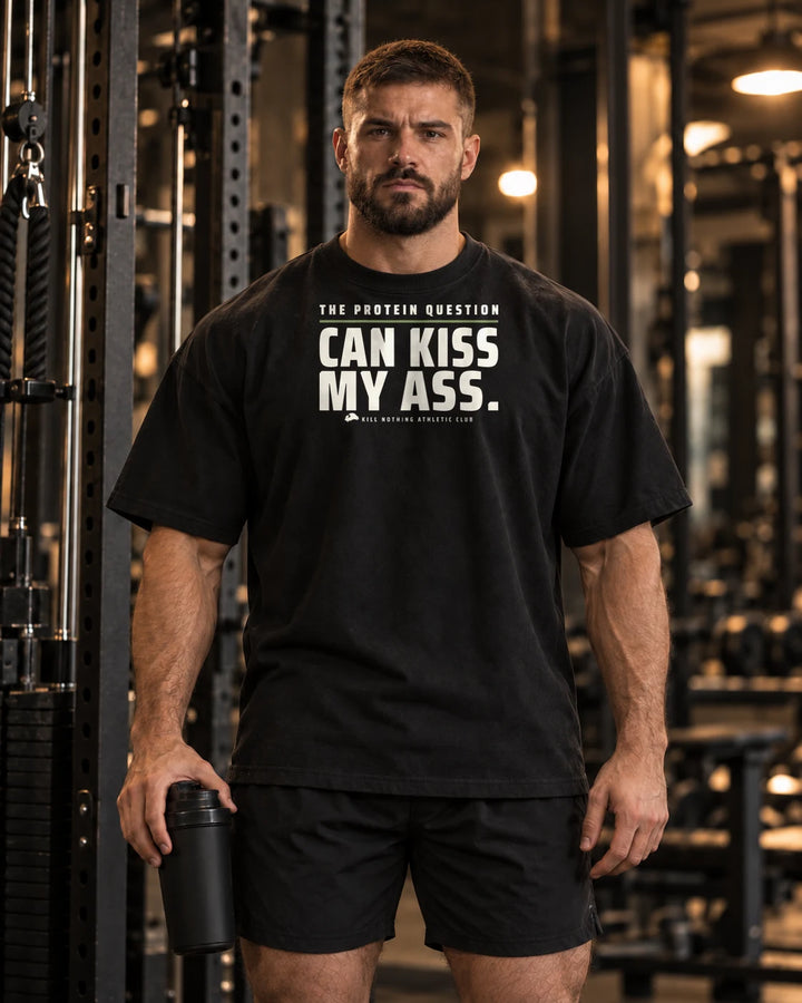 The Protein Question - Oversized Tee, black, worn by an athlete in the gym (AI-generated image)
