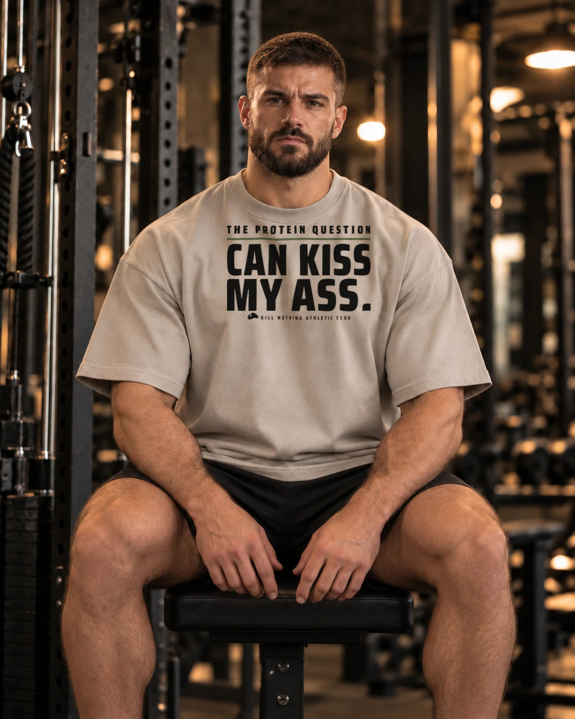 The Protein Question - Oversized Tee, stone, worn by an athlete in the gym (AI-generated image)