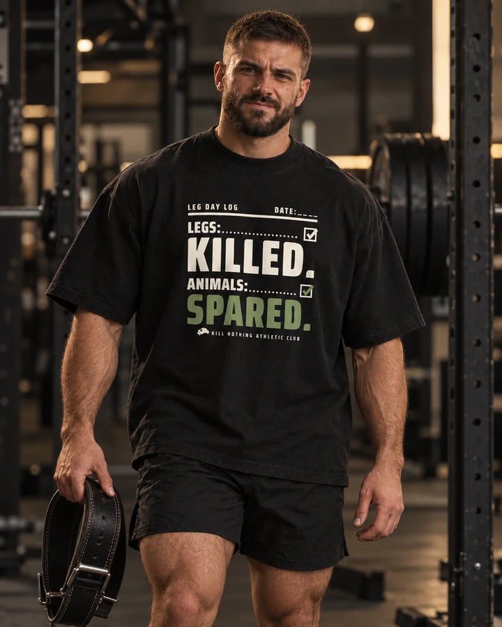 Legs: Killed. - Oversized Tee, black, worn by an athlete in the gym (AI-generated image)